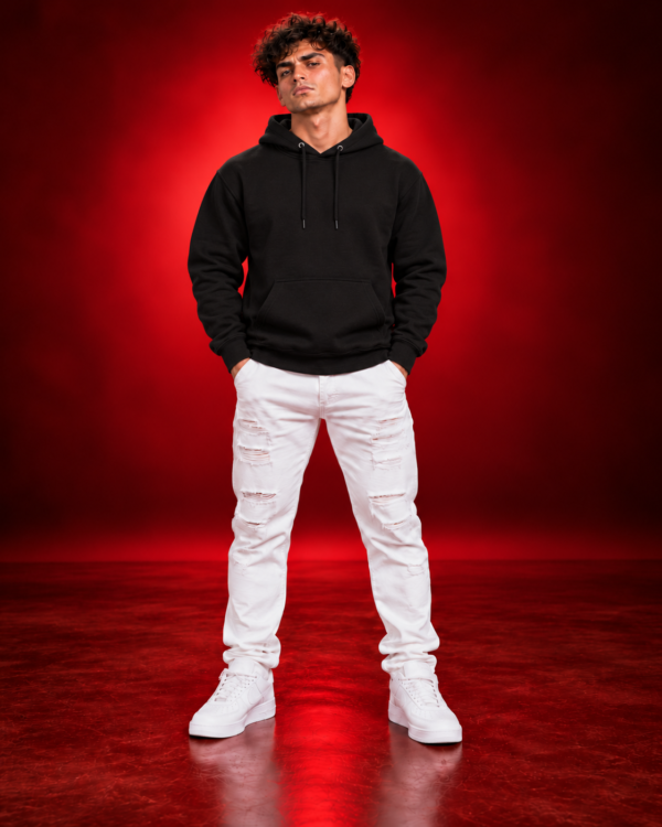 Male model wearing a black Gildan 18500 pullover hoodie, front view on a red studio background